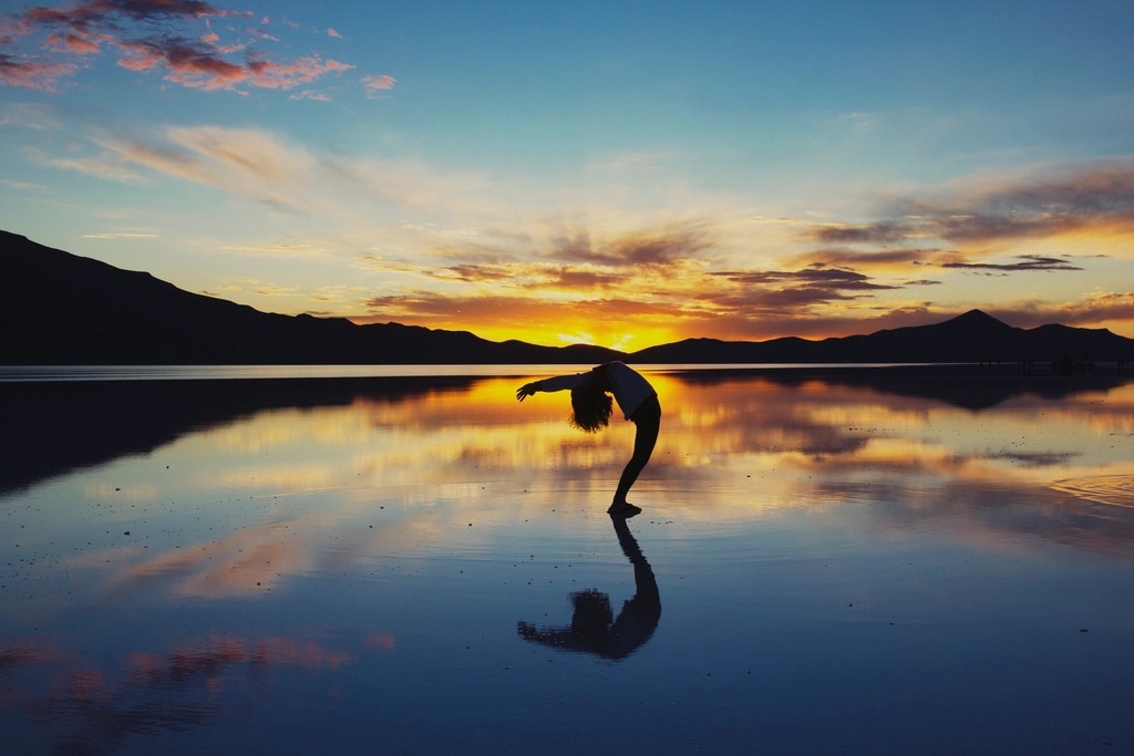 Woman doing yoga sunset
