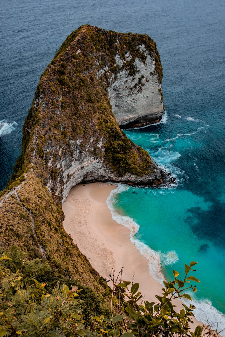high angle photo of seashore near rock formation