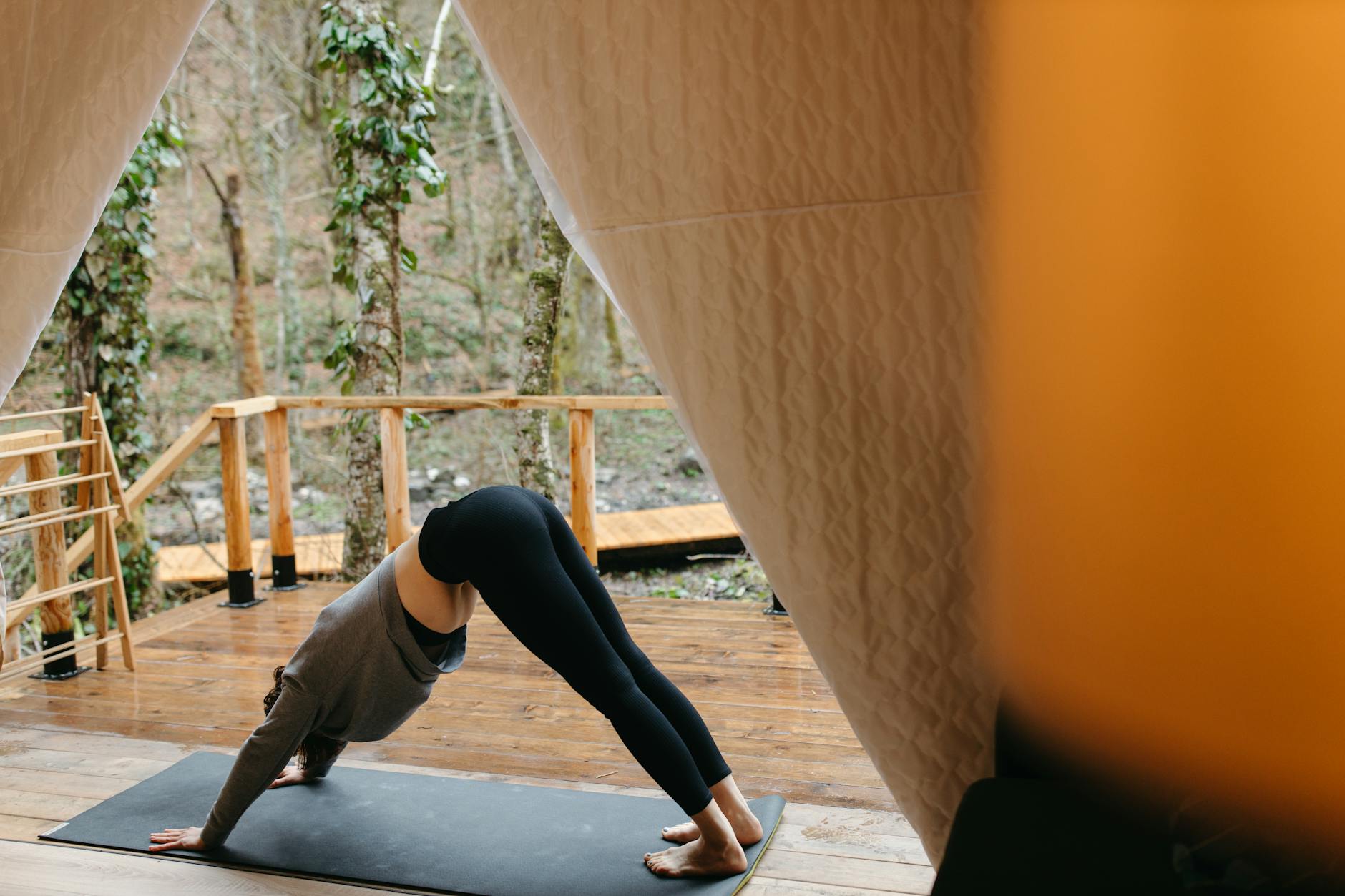 woman in black leggings doing yoga position